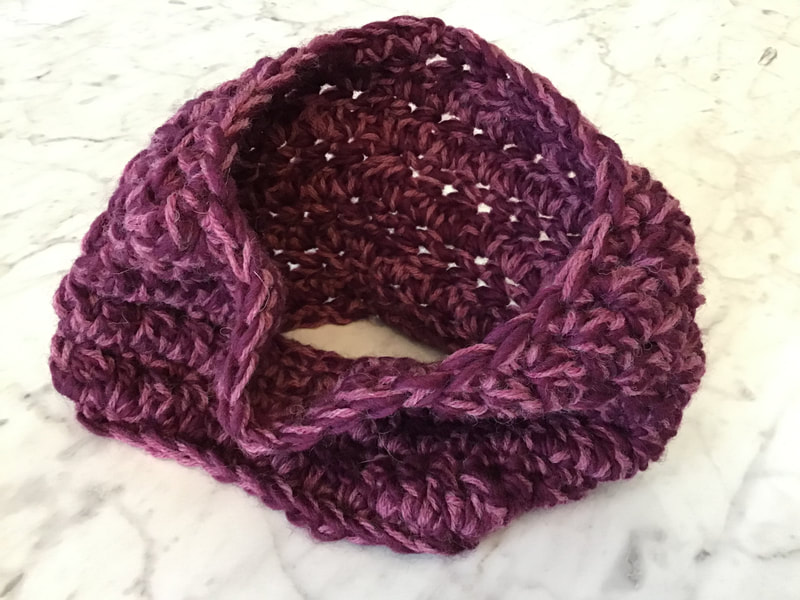 A purple cowl against a marbled background