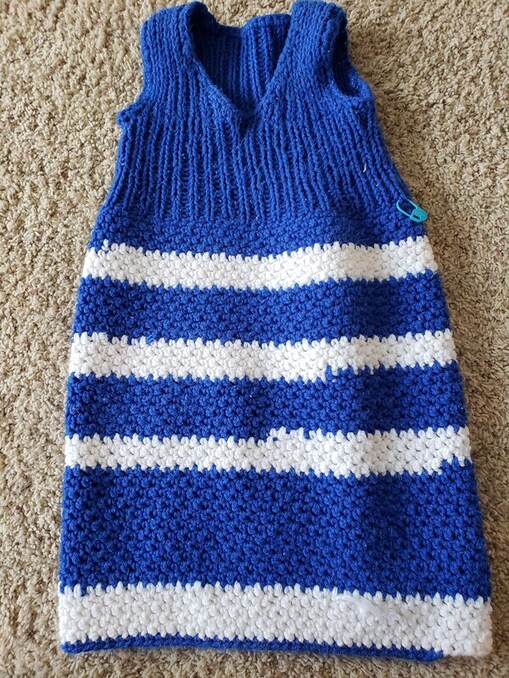 Blue and white handmade knit and crochet wearable blanket for a baby
